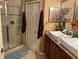 Elegant bathroom with double sinks, granite countertops, tile flooring, and a walk-in shower at 5930 Tivoli Gardens Blvd, Orlando, FL 32829