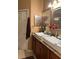 Stylish bathroom with double vessel sinks, granite counters, and warm wood cabinetry at 5930 Tivoli Gardens Blvd, Orlando, FL 32829