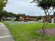 View of a community featuring townhomes, a basketball court, and green space for outdoor activities at 5930 Tivoli Gardens Blvd, Orlando, FL 32829