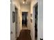 Long hallway with wood-look floors and white walls, connecting various rooms at 5930 Tivoli Gardens Blvd, Orlando, FL 32829