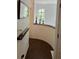 Bright hallway with modern decor leading to a staircase, adorned with decorative candles and beverages at 5930 Tivoli Gardens Blvd, Orlando, FL 32829