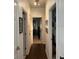 Long hallway with wood-look floors and white walls, connecting various rooms at 5930 Tivoli Gardens Blvd, Orlando, FL 32829