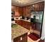 Kitchen with cherry cabinets and stainless steel appliances at 5930 Tivoli Gardens Blvd, Orlando, FL 32829