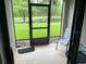 Relaxing screened patio with a view of the pond, chair, tile flooring, and black metal railings at 5930 Tivoli Gardens Blvd, Orlando, FL 32829