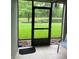 Relaxing screened patio with a view of the pond, chair, tile flooring, and black metal railings at 5930 Tivoli Gardens Blvd, Orlando, FL 32829