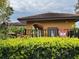 The Community Pool cabana with tile roof and tropical landscaping at 5930 Tivoli Gardens Blvd, Orlando, FL 32829