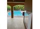 The community pool with a tile roof cabana surrounded by lush foliage at 5930 Tivoli Gardens Blvd, Orlando, FL 32829