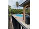 Beautiful community pool deck with tropical landscaping, lounge chairs, and cabana at 5930 Tivoli Gardens Blvd, Orlando, FL 32829