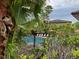 Community pool surrounded by lush tropical foliage and lounge chairs at 5930 Tivoli Gardens Blvd, Orlando, FL 32829