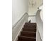 Staircase with wood treads, gray railing, and white walls leading upstairs at 5930 Tivoli Gardens Blvd, Orlando, FL 32829