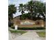 Welcoming entrance to Regal Palms at Highland's Reserve featuring lush landscaping and a stately sign at 615 Terra Lago St, Davenport, FL 33897