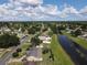 Real estate aerial view showcasing the neighborhood layout with canal and beautiful landscaping at 624 Royal Palm Dr, Kissimmee, FL 34743