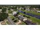 Aerial view of a home with a canal, neighborhood, and lush greenery at 624 Royal Palm Dr, Kissimmee, FL 34743