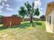 Expansive backyard featuring a utility shed, mature trees, and lush green grass at 624 Royal Palm Dr, Kissimmee, FL 34743