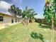 Large backyard featuring a shed, mature trees, and a well-maintained lawn at 624 Royal Palm Dr, Kissimmee, FL 34743