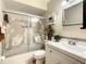 This bathroom features a bathtub with swan decals on glass sliding door, and a white sink vanity at 624 Royal Palm Dr, Kissimmee, FL 34743