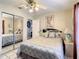 Bedroom with mirrored closet doors and a ceiling fan at 624 Royal Palm Dr, Kissimmee, FL 34743