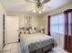 Bedroom with a mirrored closet door, ceiling fan and tiled floor at 624 Royal Palm Dr, Kissimmee, FL 34743