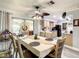 Bright dining area featuring modern light fixtures and an adjacent kitchen at 624 Royal Palm Dr, Kissimmee, FL 34743