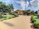 Charming home with a long driveway and lush landscaping at 624 Royal Palm Dr, Kissimmee, FL 34743