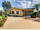 Charming home featuring a brick driveway, well-manicured landscaping, and inviting curb appeal at 624 Royal Palm Dr, Kissimmee, FL 34743