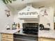 A black cooktop with neutral backsplash and decor at 624 Royal Palm Dr, Kissimmee, FL 34743