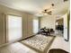 Versatile living room featuring a neutral color palette, a decorative rug, and a doorway that adds depth to the space at 624 Royal Palm Dr, Kissimmee, FL 34743