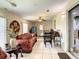 Cozy living area featuring a comfortable sofa, dining set, tile flooring, and doorway to another room, ideal for entertaining at 624 Royal Palm Dr, Kissimmee, FL 34743