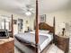 Primary bedroom with a four poster bed and tiled floors at 624 Royal Palm Dr, Kissimmee, FL 34743