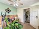 Enclosed sunroom featuring white metal gate, connection to interior space, and miscellaneous clutter, creating multi-purpose space at 624 Royal Palm Dr, Kissimmee, FL 34743