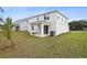 Exterior of the home with a covered patio and a grassy backyard at 630 Summit River Dr, Apopka, FL 32712