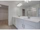 Bathroom features double sink vanity, white cabinetry, quartz countertops, and large framed mirror at 630 Summit River Dr, Apopka, FL 32712