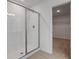 Bright white bathroom with a glass enclosed shower and doorway to walk-in closet at 630 Summit River Dr, Apopka, FL 32712