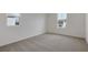 Bright bedroom with light colored carpet, multiple windows and white colored walls at 630 Summit River Dr, Apopka, FL 32712