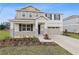 Inviting two-story home featuring a landscaped front yard and a spacious two-car garage at 630 Summit River Dr, Apopka, FL 32712