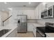 Bright kitchen featuring stainless steel appliances and white cabinetry at 630 Summit River Dr, Apopka, FL 32712