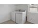 Bright laundry room with brand new washer and dryer, tile floors, and shelving unit at 630 Summit River Dr, Apopka, FL 32712
