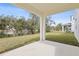 Covered patio offers an outdoor living space with views of the lawn and lush landscaping at 630 Summit River Dr, Apopka, FL 32712