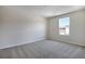 This bedroom features neutral walls, carpet, and a window providing ample natural light at 640 Summit River Dr, Apopka, FL 32712