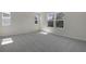 A bright bedroom featuring two windows and neutral gray walls and carpet at 640 Summit River Dr, Apopka, FL 32712