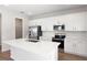 Modern white kitchen with stainless steel appliances, a central island, and a walk-in pantry at 640 Summit River Dr, Apopka, FL 32712