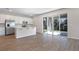 Open-concept kitchen featuring white cabinets, stainless steel appliances and a large glass sliding door to the outdoor patio at 640 Summit River Dr, Apopka, FL 32712
