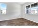 Bright room with neutral walls, beautiful wood-look tile floors, and two windows providing ample natural light at 640 Summit River Dr, Apopka, FL 32712