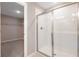 Bathroom featuring glass shower with white tile surround and chrome fixtures at 645 Summit River Dr, Apopka, FL 32712