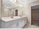Bathroom featuring double sink vanity with quartz countertops and chrome fixtures at 645 Summit River Dr, Apopka, FL 32712