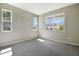 Bright, empty bedroom with plush carpet and plenty of natural light from the windows at 645 Summit River Dr, Apopka, FL 32712