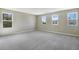 Large primary bedroom with carpet and multiple windows providing lots of natural light at 645 Summit River Dr, Apopka, FL 32712