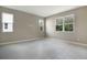 Spacious bedroom with gray flooring and three windows offering ample natural light at 645 Summit River Dr, Apopka, FL 32712