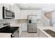 Contemporary kitchen with stainless steel appliances, sleek white cabinetry, and quartz countertops at 645 Summit River Dr, Apopka, FL 32712