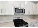 Close-up of a modern kitchen showcasing stainless steel appliances and quartz countertops at 645 Summit River Dr, Apopka, FL 32712